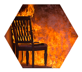 wooden chair with seat cushion engulfed in flames